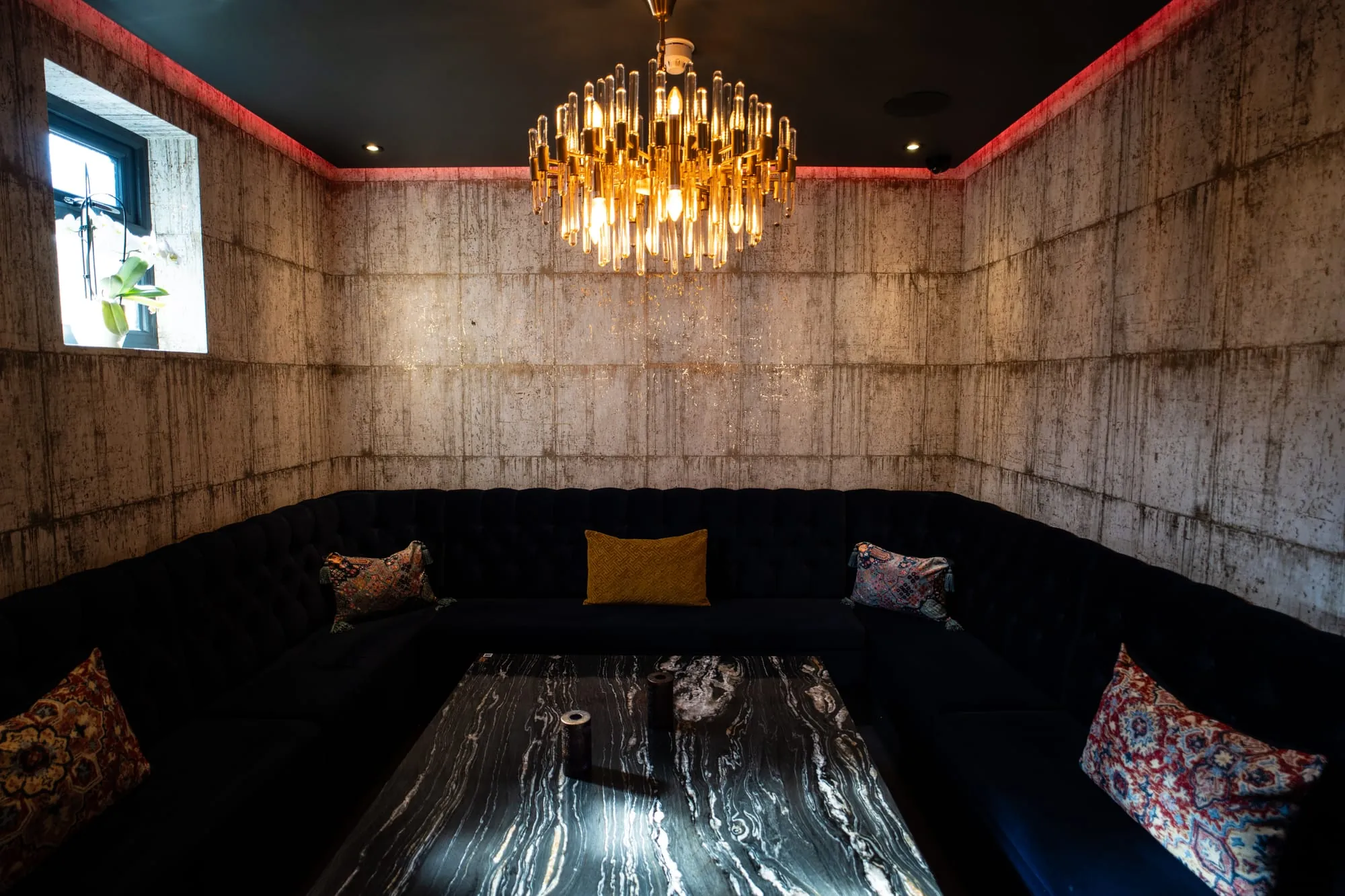 VIP lounge with chandelier and velvet seating at Fire & Ice, Hatch End London